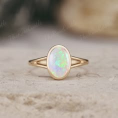 Unique Opal Engagement Ring Solid Gold Rings Art Deco Bezel Set Ring Vintage Oval cut Rainbow Opal Ring Minimalist Wedding Rings For Women ITEM DETAILS ●Available in yellow, white or rose solid 10k, 14k or 18k gold. This ring can be made in Platinum. ❀❀Center Stone: Natural Opal Shape: Oval shape Size: 6x9mm Band width around 1.5mm Visit my shop for more jewelry: https://www.etsy.com/shop/TheRoseCastle if you would like to customize your unique ring, you may contact us about your ideas and pictures. Hope I could get the chance to create fabulous rings for you! ❀Production ---- This ring is handmade and very good quality! Please allow 2-4 weeks for production. It can be made to any ring size.  ❀Engraving service We accept the engraving order, leave a note when placing an order or contact us Opal Ring Bezel Set, Opal Bezel Ring, Bezel Opal Ring, Minimalist Oval Cabochon Wedding Jewelry, Oval Opal Ring For Anniversary, Minimalist Oval Halo Ring, Oval 14k Gold Opal Ring, Classic Oval Bezel Set Opal Ring, Oval Opal Promise Ring