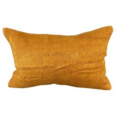 an orange pillow on a white background