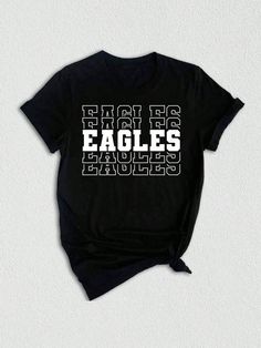 Introducing our Team Mascot Shirt, a must-have for all proud Eagles!  Show off your team spirit and pride with this Eagles School Shirt, designed to celebrate your love for the Eagles and their glorious mascot. This Eagles Mascot Tee is perfect for game days, pep rallies, or simply to represent your team wherever you go. Crafted with premium quality materials, this Eagles Pride Shirt ensures comfort and durability. The soft fabric keeps you feeling cozy, while the vibrant design showcases your l College Fan Apparel T-shirt With Team Name, Collegiate T-shirt With Name Print For Fans, Sports Fan Graphic Print T-shirt For College, Team Spirit T-shirt With Team Name For College, Short Sleeve Tops For Game Day With School Spirit, Short Sleeve Tops For Game Day School Spirit, School Spirit Tops With Team Logo For Fan Gear, Team Spirit T-shirt With Letter Print For Fans, Sporty Shirt For College Sports Season