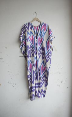 This Cotton ikkat Kaftan Is made From incredibly soft and lightweight cotton and is versatile for many occasions. It is so free flowing that it will make you feel as you are not wearing anything at all. The beauty of Front open kaftan is that they will fit everyone. You can wear it as a kaftan and kimono also.  The perfect floral print Kaftan is used to Lounge Wear, Resort Wear, Party Dress, beach Cover up, House Working Dress and use for a dinner party or just slip into in on a beautiful summer Multicolor V-neck Kaftan With Batik Print, Bohemian Multicolor V-neck Thobe, Multicolor Ikat Print Long Sleeve Kaftan, Long Sleeve Multicolor Ikat Print Kaftan, Multicolor Long Sleeve Ikat Print Kaftan, Purple Free Size Long Kaftan, Summer Multicolor Ikat Print Kimono, Multicolor Ikat Print Kaftan For Festivals, Bohemian Kaftan With Ikat Print And Kimono Sleeves