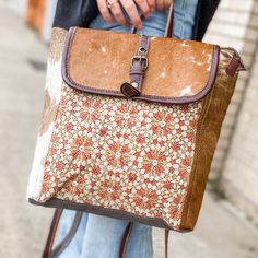 We Love The Fun, Bright Look Of This Backpack! It Has A Patterned Center With Cowhide & Leather Trimmings. It Has A Zipper & Magnetic Closure To Keep All Your Items Secure! The Middle Features Two Open Pockets, And A Zippered Pocket To Keep All Your Things Organized! -Cowhide Colors Vary Slightly- Height: 12" Depth: 4" Width: 15" Brown Square Backpack For Everyday Use, Beige Shoulder Bag Backpack For Errands, Beige Shoulder Backpack For Errands, Yellow Square Satchel For Travel, Multicolor Backpack With Removable Pouch For Everyday, Multicolor Backpack For Everyday Use, Multicolor Leather Backpack With Adjustable Strap For Everyday Use, Yellow Bags With Adjustable Strap For Errands, Multicolor Leather Satchel Backpack For Everyday Use