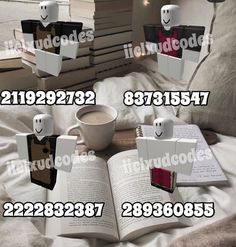 an open book sitting on top of a bed next to two mugs and books