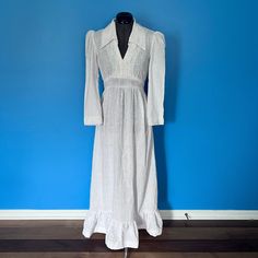 "Tonight's vintage offering is this lovely homemade / handmade 1970s boho prairie dress in a slubby, rustic white cotton. This beautiful dress has a deep v-neckline, a deep folded collar, flared sleeves and a tiered hemline.  The bodice and the collar are trimmed in lace and there are attached ties to cinch the waists. There are no closures -- it slips on over one's head.  The dress is freshly laundered and in excellent condition.  The previous owner must have worn the dress a couple of inches l Vintage Linen Maxi Dress For Summer, Vintage Cotton Maxi Dress With Long Sleeves, Vintage Cotton Long Sleeve Maxi Dress, Vintage Long Sleeve Cotton Maxi Dress, Fitted Long Sleeve Linen Prairie Dress, Vintage Linen Beach Dress, White Cotton Bohemian Prairie Dress, White Bohemian Cotton Prairie Dress, White Long Sleeve Bohemian Prairie Dress