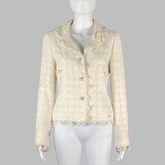 Chanel Jacket Comes In A Cream Boucle Cotton Blend With A Full Monogram Liner Featuring A Notch Lapel, Camelia Pin Detail, Silver Tone Buttons, And A Three Button Closure. Made In France. Very Good Pre-Owned Condition. Small Mark At Sleeve. Marked: Al639 05c / 36 Measurements: Shoulder: 15 Inches Bust: 34 Inches Sleeve: 25 Inches Length: 20.5 Inches Sui Generis Reference: 130110 Category: Jacket (Indoor) / Blazer More Details Brand: Chanel Gender: Female Color: Cream Fabric: Cotton Material: Bou Luxury Cream Outerwear With Double-breasted Button, Cream Single-breasted Tweed Outerwear, Luxury Double-breasted Blazer With Snap Buttons, Cream Notch Lapel Blazer With Double-breasted Buttons, Chanel Cream, Luxury Beige Single-breasted Cropped Jacket, Chanel Jackets, Resale Store, Chanel Jacket