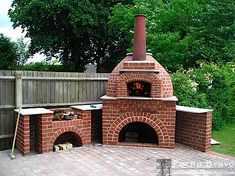 an outdoor brick pizza oven in the backyard