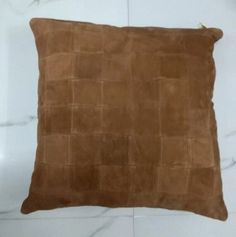 a brown pillow sitting on top of a white counter