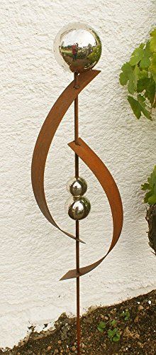 a metal sculpture with three balls on it