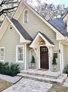 the exteriors website is displayed in front of a gray house with white trim and windows