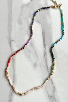 Update your jewelry collection with our Luisa Necklace! This dainty choker features a variety of colors and a cute seed bead design. With a lobster claw closure and 3" extension, it's easy to adjust to your desired length. Plus, the 14" chain adds a touch of elegance. Please note that actual colors and patterns may vary slightly. Dainty Beaded Necklace With Lobster Clasp, Gift Beaded Necklaces With Adjustable Length And Round Beads, Gift Beaded Necklaces With Adjustable Length, Adjustable Tiny Beads Charm Necklace As Gift, Adjustable Multicolor Tiny Beads Choker, Adjustable Charm Necklaces With Tiny Beads As Gift, Adjustable Length Beaded Necklaces With Round Beads As Gift, Trendy Adjustable Length Necklaces For Festivals, Adjustable Dainty Multicolor Choker