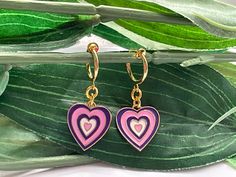 Pretty little earrings! For those that want to wear hoops but do not have pierced ears! Perfect These are made with a gold tone spring clip on hoops (13mm) with gold tone purple/pink hearts (12mm) attached  This is a set of 2 hoops More Gold hoop Clips https://www.etsy.com/uk/listing/704679868/pearl-hoop-dangle-clip-on-earrings-girls?ref=shop_home_active_68&sca=1 ESTIMATED DELIVERY TIMES SHIPPING FROM UK: UK: Royal Mail First Class:  1-3 business day Canada: Royal Mail Standard International Shipping:  7-30 business days North America: Royal Mail Standard International Shipping:  7-21 business days Europe: Royal Mail Standard Shipping:   3-10 business days Australia, New Zealand and Oceania: Royal Mail Standard International Shipping:  7-31 business days May vary during busy periods Once y Playful Hoop Jewelry Gift, Playful Hoop Jewelry As A Gift, Playful Hoop Jewelry As Gift, Playful Small Hoop Jewelry For Gifts, Playful Small Hoop Jewelry Gift, Cute Hypoallergenic Huggie Earrings, Playful Pink Hoop Earrings Gift, Pink Drop Huggie Earrings, Cute Hypoallergenic Hoop Earrings