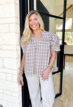 This neutral plaid blouse features puff sleeves and ruffle detailing for a touch of femininity. Add this versatile top to your wardrobe to easily elevate any outfit. This top is perfect for all season long! By Entro Model is 5'4 wearing a small Fits true to size 100% cotton Relaxed Fit Cotton Blouse With Ruffle Sleeves, Fall Casual Puff Sleeve Top With Ruffles, Casual Puff Sleeve Top With Ruffles For Fall, Feminine Cotton Puff Sleeve Top For Fall, Casual Puff Sleeve Top With Ruffle, Cotton Tops With Ruffles For Casual Gatherings, Chic Short Sleeve Plaid Blouse, Casual Cotton Puff Sleeve Top With Ruffles, Fall Ruffled Puff Sleeve Top For Workwear