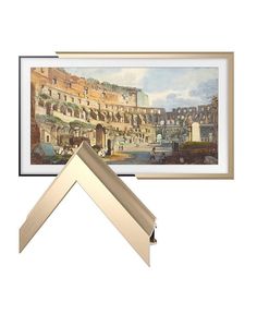 a painting hanging on the wall next to a frame with an image of a city