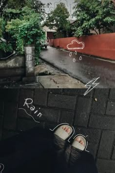 someone's feet are drawn on the ground next to a street with buildings and trees