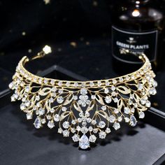 Up your sparkle factor with this romantic tiara design that can complete the most sophisticated of bridal looks. Intricately faceted cubic zirconia work their way across the band and capture the light from every angle with a perfectly translucent appeal. Cast in lightweight alloy and silver/yellow gold/rose gold plated for a flawless finish, the headband measures 2.5" at the tallest point (approx. 6.3cm) and 6" in diameter (approx. 15cm). Two small loops at each end make it easy to attach to you Luxury Adjustable Wedding Headpieces, Luxury Adjustable Headpieces For Weddings, Teardrop Crown Jewelry With Rhinestones For Wedding, Wedding Headpiece With Rhinestones And Round Crown, Luxury Wedding Crown Jewelry, Elegant Crystal Headpieces For Weddings, Cubic Zirconia Bridal Necklace For Wedding, Wedding Bridal Necklace With Cubic Zirconia, Elegant Gold Crown With Rhinestones