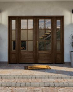 the front entrance to a house with two large doors