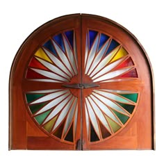 a wooden door with stained glass in the center