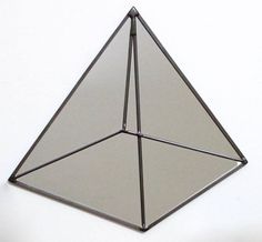 a triangle shaped mirror hanging on the wall