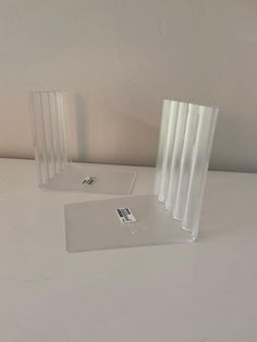 three clear vases sitting on top of a white table