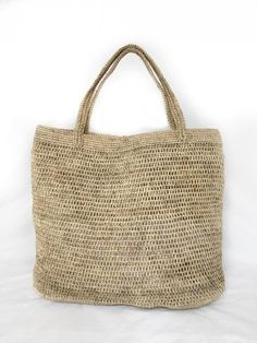 Stylish and on trend, this beautiful tote is handmade by artisans from Santander, Colombia. 100% made of Fique natural fiber, a plant similar to Agave, it is the perfect summer accessory to be used out in the city or to spend a day at the beach. With two easy to carry handles, you will want to carry it around everywhere you go!Approximate Dimensions:Width: 17.8” / 45 cmHeight: 14.5" / 37 cmDepth: 3.1" / 8 cmStrap drop: 8.7"/ 22 cmAll of our bags are 100% handmade from natural fibers. Please allo Artisan Straw Bag For Beach, Fair Trade, Eco-friendly Handwoven Shoulder Bag For Beach, Eco-friendly Natural Fiber Beach Bag With Open Weave, Eco-friendly Handwoven Beach Shoulder Bag, Eco-friendly Straw Beach Bag With Open Weave, Handwoven Bag, Boho Handbags, Summer Tote, Colorful Scarf