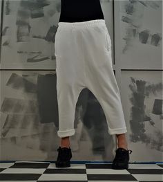 White Loose Fit Ankle-length Harem Pants, White Ankle-length Harem Pants With Loosely Fitted Hips, White Baggy Casual Harem Pants, White Baggy Cargo Pants With Hip Pockets, White Harem Pants With Pockets And Loose Fit, Oversized Long Pants With Pockets, Oversized Straight Leg Bottoms With Pockets, Loungewear Straight Pants With Hip Pockets, White Harem Pants With Pockets For Loungewear