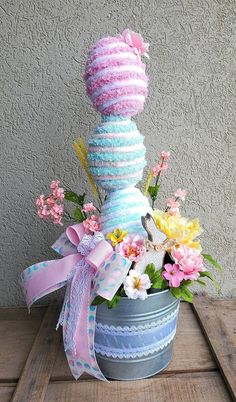 a potted plant with flowers in it sitting on a table