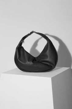 Bode is crafted in the USA from soft 100% regenerative leather, the slouchy zip-top silhouette features an open interior and is finished with an integrated, adjustable shoulder strap. This functional bag can be worn over the shoulder, across the body, or carried by hand. Minimalist Top Handle Hobo Bag With Removable Pouch, Modern Shoulder Bag With Removable Pouch And Round Handle, Modern Shoulder Bag With Single Strap For On-the-go, Modern Hobo Bag With Top Handle And Adjustable Strap, Modern Shoulder Hobo Bag, Modern Crossbody Hobo Bag With Handle Drop, Modern Hobo Bag With Round Handle For Everyday, Everyday Bucket Bag With Top Handle And Single Strap, Modern Hobo Shoulder Bag With Detachable Handle