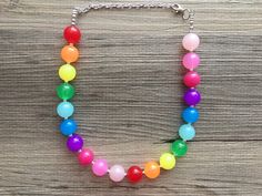 "Simply Gorgeous!! Colorful beaded necklace in rainbow colors. These beads have a bubblegum shape and size and are jelly acrylic. Silver finishing. 16\" Necklace with a 4\" extender chain. Thank you for supporting American small and handmade business! Check out our other items: Www.PolkaDotDrawer.Etsy.com" Playful Colorful Beads Necklaces For Birthday, Playful Colorful Beads Necklace For Birthday, Playful Party Necklaces With Colorful Beads, Playful Round Beads Necklaces For Parties, Multicolor Beaded Necklaces For Birthday, Rainbow Round Bead Adjustable Necklace, Adjustable Rainbow Round Bead Necklaces, Playful Rainbow Necklaces With Round Beads, Playful Rainbow Beaded Necklaces