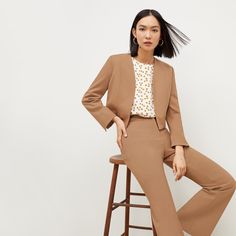 This chic suiting staple features clean lines, a slightly cropped hemline, an internal pocket, and strategically placed seams designed to flatter. Tailored Cropped Jacket With Notch Lapel For Semi-formal Occasions, Spring Season Notched Business Suits, Spring Cropped Blazer For Business Casual, Spring Notched Suits With Welt Pockets, Spring Suits With Welt Pockets And Notched Shape, Elegant Cropped Pantsuit For Office, Notch Lapel Cropped Jacket For Office In Spring, Spring Cropped Jacket With Notch Lapel For Office, Spring Office Cropped Jacket With Notch Lapel