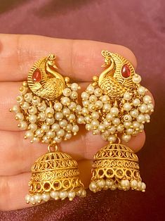 These exquisite Antique Peacock Earrings come in 4 beautiful colors and are perfect for adding a touch of elegance to any Indian outfit. Crafted with intricate antique detailing, these earrings are a must-have for any fashion-forward individual. Elevate your style with these stunning pieces. Length - 5cm Jewellery Care- Keep the jewelry dry, avoid heat and contact with perfumes & water. Elegant Peacock Design Chandelier Earrings, Elegant Peacock Design Earrings For Festivals, Gold Peacock Design Danglers For Party, Elegant Peacock Design Earrings For Party, Elegant Peacock Design Danglers For Parties, Ornate Peacock Design Earrings For Celebration, Elegant Peacock Design Dangle Earrings, Elegant Peacock Design Earrings For Festive Occasions, Elegant Dangle Earrings With Peacock Design