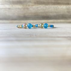 These beautiful rings, will make you look expensive, whilst also being on a budget😉. Handmade out of 0.8mm transparent elastic string, gold and blue seed beads and crystal beads. Make sure to select your ring size and your option, in the sections above.  💖Check out our other ring collections: https://www.etsy.com/shop/Zooheela?ref=seller-platform-mcnav&section_id=48579398 ABOUT DELIVERY: Shipment time might vary, depending on where you live; however, we place a huge importance on the delivery Blue Stackable Jewelry With Round Beads, Adjustable Round Band Bracelet For Gift, Adjustable Blue Birthstone Jewelry, Adjustable Faceted Rondelle Beads Jewelry, Adjustable Rondelle Faceted Bead Jewelry, Dainty Blue Bangle, Dainty Blue Bangle Jewelry, Blue Spiritual Stackable Jewelry, Adjustable Round Band Crystal Ring With Gemstone