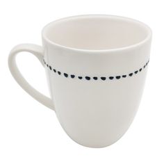 a white coffee cup with black dots on the rim and handle is sitting in front of a white background