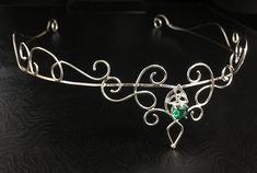 I have fabricated a sterling silver wedding circlet, or bridal tiara, which is designed to be worn for a wedding, a Renaissance event, or perhaps a hand-fasting ceremony. A beautifully handmade circlet with an elegant, Princess feel, yet still elegant to be worn and enjoyed for any high end function! This piece will go around behind the ears and is tied off, in the back, by an elastic jeweler's cord so that it will remain snug and in place while in motion. This works better than using a chain li Elegant Ceremonial Crown Headpieces, Silver Headband Crown For Wedding, Elegant Handmade Headpiece With Structured Crown, Wedding Jewelry With Crown Design, Elegant Ceremonial Headpiece With Pinched Crown, Silver Crown Headpiece For Wedding, Elegant Ceremonial Handmade Headpieces, Elegant Handmade Ceremonial Headpieces, Elegant Silver Crown For Wedding