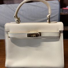 Carbotti Handbags Are Made In Italy. This Cream Color Bag Would Be An Ideal Everyday Medium Sized Purse. Timeless Beige Shopping Bag, Classic Tan Box Bag For Shopping, Classic Box Bag With Gold-tone Hardware For Shopping, Classic Shopping Box Bag With Gold-tone Hardware, Classic Beige Bags For Formal Occasions, Timeless Cream Rectangular Bag, Timeless Cream Rectangular Bags, Classic Beige Formal Bags, Classic Box Bag With Handles