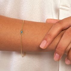 Real 14K Gold Mini Evil Eye Adjustable Bracelet for Women | Yellow Gold, 7.5 Inches (6.5+1) | 0.80mm Chain Thickness Protect yourself with style using our elegant 14K Gold Mini Evil Eye Adjustable Bracelet for Women. Crafted in luxurious yellow gold, this dainty bracelet features a mini evil eye charm believed to ward off negative energy and bring good luck. The adjustable design ensures a perfect fit, with a length of 7.5 inches and a chain thickness of 0.80mm. Finished with a secure lobster closure, this bracelet is both fashionable and functional, making it a must-have accessory for any modern woman. * Stylish 14K yellow gold bracelet with a mini evil eye charm * Length: 7.5 inches (6.5+1) ; Chain thickness: 0.80mm * Adjustable design for a customizable fit * Features a secure lobster c Elegant Yellow Gold Bracelets For Birthday Gift, Elegant Yellow Gold Bracelet For Birthday Gift, Elegant Yellow Gold Bracelet For Birthday, 14k Yellow Gold Bracelets For Birthday Gift, Yellow Gold May Birthstone Bracelets For Anniversary, Yellow Gold Bracelets For Anniversary, May Birthstone, Yellow Gold 14k Bracelets For Birthday Gift, Yellow Gold Birthstone Bracelets For Wedding, 14k Gold Birthstone Bracelet For Anniversary