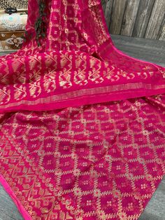 Lightweight, soft Dhakai Jamdani! Create a striking statement with this bold pink saree with gold Zari jaal.  Fall attached. Dry Clean Only Traditional Pink Pre-draped Saree For Diwali, Pink Saree With Dupatta For Celebration, Festive Pink Saree With Dupatta, Pink Chanderi Saree With Self Design, Pink Saree With Pallu For Eid, Pink Saree For Eid Celebration, Pink Zari Work Saree For Celebration, Unstitched Pink Saree With Self Design, Pink Unstitched Saree With Self Design