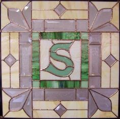 a stained glass window with the letter s on it