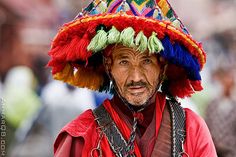 an old man wearing a colorful hat on his head