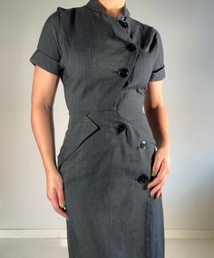 This dress is classic, and it has a beautiful fit. I sourced this is San Francisco. It's in perfect condition, not a button out of place. I believe the dress is 100% cotton. Please reach out with any questions.  Measurements Shoulder: 14 inches Sleeve length: 7 inches  Waist: 13 inches Hip: 18.5 inches Length: 42 inches Bottom opening: 22 inches PLEASE READ MEASUREMENTS *All items are measured flat. Measurements are not doubled.* EXCHANGE/STORE CREDIT ONLY Please view return policy DISCLOSURE Some items have been professionally cleaned and altered. Photos and measurements reflect the current state of the item. All additional care is the responsibility of the buyer. Fitted Cotton Dress With Buttons, Fitted Knee-length Dresses With Buttons, Classic Cotton Midi Dress For Office, Classic Knee-length Vintage Dress For Work, Classic Cotton Knee-length Midi Dress, Classic Knee-length Cotton Midi Dress, Elegant Cotton Shirt Dress With Button Closure, Elegant Vintage Cotton Dress, Midi Length, Cotton Knee-length Dress With Fitted Waist