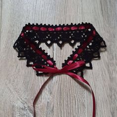 This handmade crochet black lace choker necklace is tied with a claret colour satin ribbon. A simple yet elegant accessory that will work well with a lot of looks. The choker is similar to the Victorian lace collar. Teenagers, who prefer clothes in the Gothic style, also like to wear them to emphasize their individuality. The choker can be used as an additional accent for creating costumes for Cosplay. Made from 100% high-quality mercerized cotton. Choker length 35 cm / 13,8 inches, width - 4,6 Black Ribbon Choker As A Gift, Black Ribbon Choker Gift, Black Ribbon Choker For Gifts, Black Ribbon Choker For Party, Handmade Black Wedding Choker, Handmade Black Choker For Wedding, Black Lace Choker Necklace, Choker Necklace Handmade, Diy Choker