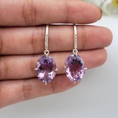 This Jewelry Earrings comes with a 100% Natural Amethyst by Gemstone, and it is made up of 925 solid sterling silver. This Jewelry set is handcrafted by our skilled craftsmen and designed by us. Every gemstone is handpicked for the best quality. Material :- Silver (925 Solid Sterling Silver) Gemstone :- Natural Purple Amethyst All Item Weight :-6 Grams Approx. Stone Shape :- Oval Cut Gemstone Size :- 12x16 MM Secondary Stone : 1.5MM Round Cut White Topaz Payment Policy :- We accept payment throu Bridesmaid Gifts Earrings, Purple Bridesmaids, Purple Earrings, Bridesmaid Earrings, Silver Earrings Dangle, Bridesmaid Jewelry, White Topaz, Hook Earrings, Purple Amethyst