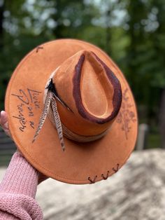 "Livin' on a prayer" handcrafted western wide brim...🤠 Product details: Suede western wide brim/"Livin' on a prayer" quote/Burned flower bundle/suede stitched x's/pheasant feathers/twisted rope hat band. Handmade Western Fedora For Western-themed Events, Distressed Bohemian Hat Band For Festivals, Rustic Handmade Hat Bands For Rodeo, Distressed Bohemian Hat For Festivals, Handmade Rustic Hat Bands For Rodeo, Distressed Bohemian Hat Bands For Festivals, Handmade Rustic Rodeo Hat Bands, Bohemian Distressed Hat Bands For Festivals, Handmade Rustic Hat Band For Festivals