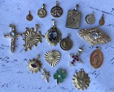 Lovely French Antique Pendants Old Charms 18K 24K 8K Goldfilled and vintage German golden metals choose from this set of 18 Beautiful Vintage Charms Pendants, rare selection, they are all unique and in good condition, found in France, Belgium, Netherlands, Germany Spain and Italy. the flower medaillon photo locket and the moon charm also libra charm is goldplated, the star and the little holy may hangers, the angel and the biggest antique French pendant (with stone) are gold-plated en gold filled! Beautiful brass and antiqued metals too. Unique, rare and amazing jewelry set, all charms come wit eye clips and beautiful stainless steel chains 22 inch (adjustable) in matching color!  Choose yours from this 18  pieces set , select the charms from the dropdown menu, the numbers are shown on the Gold Necklaces With Charms For Vintage Collection, Antique Gold Jewelry With Charms, Gold Vintage Charm Costume Jewelry, Gold Costume Jewelry With Vintage Charm, Gold Jewelry For Vintage Collection, Victorian Gold Jewelry With Charms, Heirloom Gold Jewelry With Vintage Charm, Antique Gold Necklace With Charms, Antique Gold Necklaces With Charms