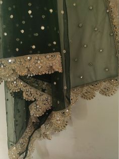 two pieces of clothing with beading on them and one piece in the middle is green