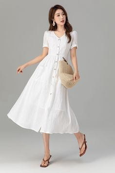 "This elegant white linen dress is a classic piece that embodies simplicity and comfort. Its crisp white color exudes a fresh and clean aesthetic, perfect for warm weather.Seamlessly pair this minimalist style linen dress with a breezy blazer and slides for sleek office wear.Alternatively, dress it up with floral or ruffle-adorned linen summer dresses for special festivities. Details: * 100% linen  * White cotton lining * Two front pockets * Front buttons closure * V-neck dress, A line dress * S Feminine Summer Midi Dress In Solid Color, Feminine Solid Color Midi Dress For Summer, Feminine Solid Color Midi Summer Dress, Feminine Solid Color Summer Midi Dress, Elegant Linen Midi Dress, Chic Linen Midi Dress, Summer Vacation Linen Dress In Solid Color, Elegant Solid Color Maxi Dress For Day Out, Elegant Solid Color Summer Midi Dress