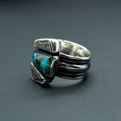 This piece features a piece of natural Turquoise balanced between two beautifully unique silver boxes. During your day, we envision this ring will remind you that balance leads to harmony, and your harmony is vital to your wellbeing. Perfect for any outfit, this ring wears well any day of the week. Natural Turquoise and .925/.999 silver. This ring is a size: 9(US) Setting size: 15X22mm (stone 14X8mm) Sterling Silver Turquoise Ring For Healing With Natural Stones, Spiritual Turquoise Ring With Natural Stones In Sterling Silver, Spiritual Sterling Silver Turquoise Ring With Natural Stones, Modern Polished Turquoise Ring In Sterling Silver, Modern Turquoise Ring In Sterling Silver With Polished Finish, Modern Sterling Silver Turquoise Ring With Polished Finish, Modern Turquoise Sterling Silver Ring With Polished Finish, Sterling Silver Turquoise Ring For Healing, Modern Turquoise Ring For A Gift