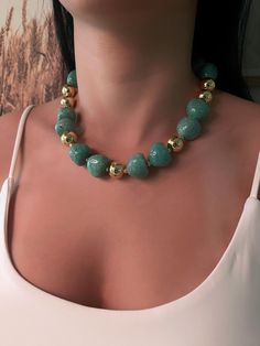 Elevate your style with the exquisite "Golden Elegance" necklace. Featuring a striking combination of jade green beads and polished golden accents, this statement piece is perfect for any occasion. The beads are meticulously crafted to give off a luxurious and timeless vibe, while the gold-tone spheres add a touch of sophistication. Whether you're dressing up for a special event or adding a bold accessory to your everyday wear, this necklace is sure to turn heads. High-quality materials Bold and Affordable Green Elegant Pearl Necklace, Luxury Beaded Jade Necklace, Luxury Green Statement Beaded Necklace, Cheap Jade Beaded Necklaces, Gold Jade Gemstone Beaded Necklaces, Gold Jade Beaded Necklaces With Gemstones, Gold Jade Beaded Necklaces With Gemstone Beads, Green Gemstone Party Beads, Gold Jade Beaded Necklaces With Round Beads