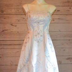 a white dress with blue flowers on it