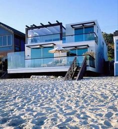 a beach house with stairs leading up to it