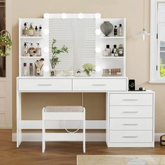 a white vanity with lights on it in a room