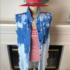 a mannequin wearing a blue jean vest and red hat